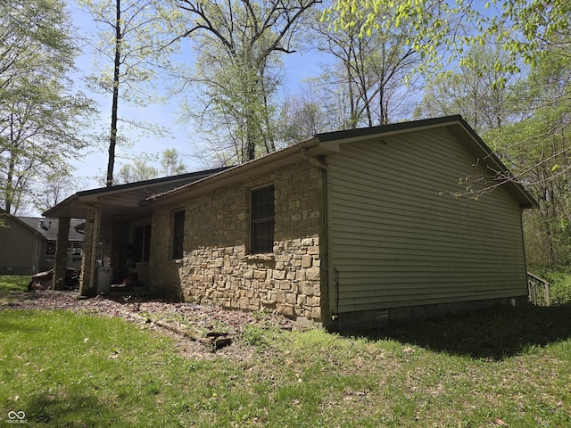 view of property exterior with stone siding, crawl space, and a lawn