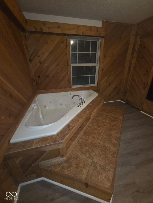 885 S Norkay St, North Vernon, IN 47265 - bathroom featuring a jetted tub and wood walls