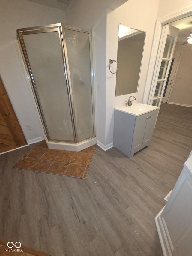 885 S Norkay St, North Vernon, IN 47265 - full bath featuring wood finished floors, vanity, a stall shower, and a ceiling fan
