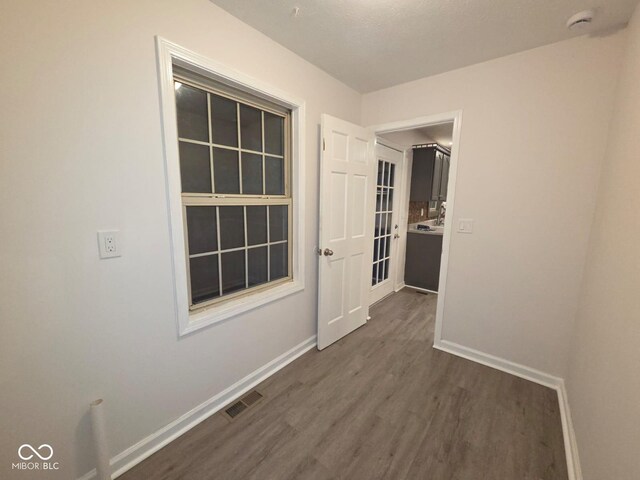 885 S Norkay St, North Vernon, IN 47265 - unfurnished room with dark wood-style flooring and a smoke detector
