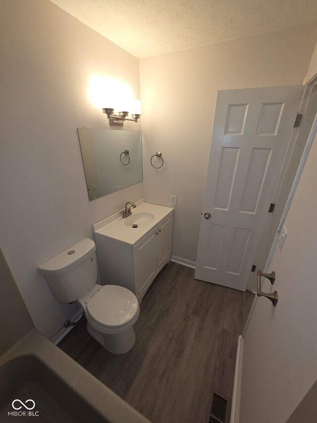 885 S Norkay St, North Vernon, IN 47265 - bathroom with wood finished floors, vanity, and a textured ceiling