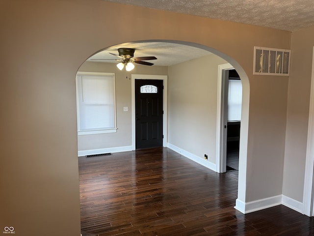 3720 W 16th St, Indianapolis, IN 46222 - foyer entrance with arched walkways, ceiling fan, baseboards, dark wood-style floors, and a textured ceiling