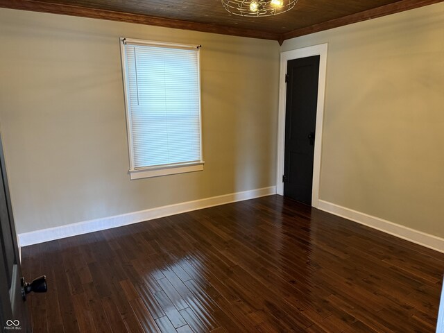 3720 W 16th St, Indianapolis, IN 46222 - spare room featuring crown molding, baseboards, and dark wood finished floors