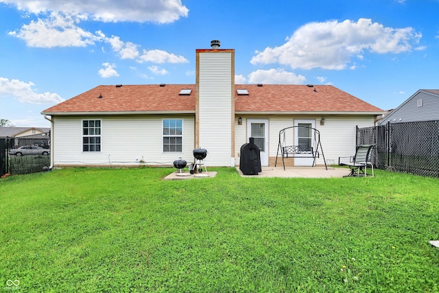 rear view of house with a patio area, a chimney, and roof with shingles