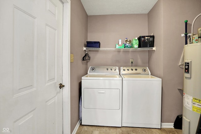 laundry area with independent washer and dryer, water heater, and baseboards