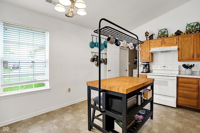 kitchen with white electric stove, a chandelier, healthy amount of natural light, and under cabinet range hood
