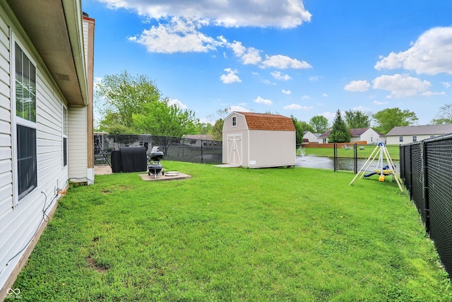view of yard featuring a shed and an outbuilding