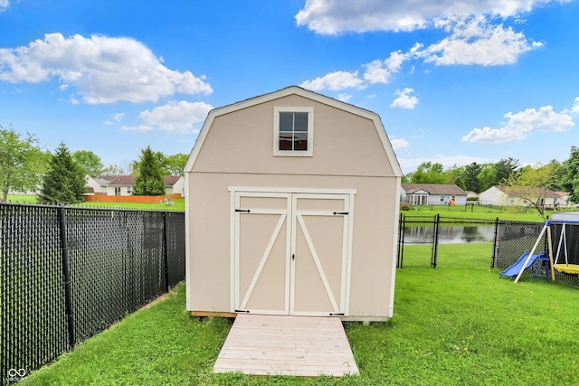 view of shed featuring a water view and a residential view