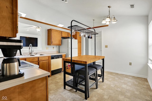 kitchen with white appliances, a sink, light countertops, brown cabinets, and a ceiling fan