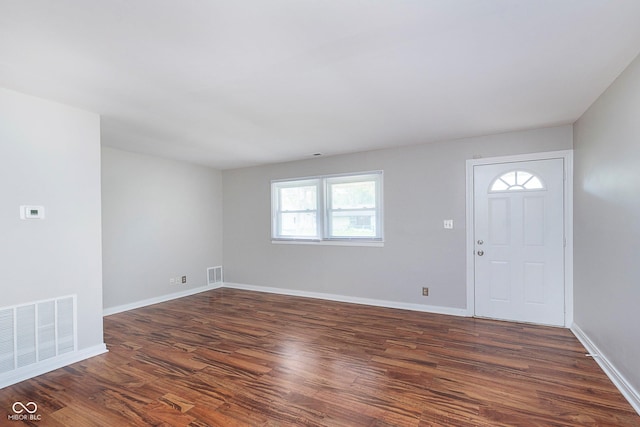 entrance foyer with dark wood finished floors and baseboards