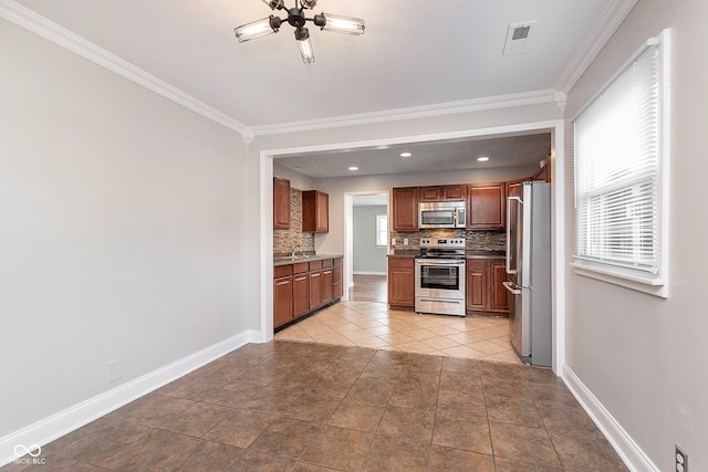 kitchen featuring stainless steel appliances, backsplash, ornamental molding, ceiling fan, and baseboards