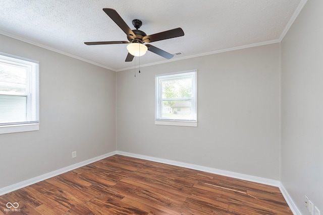 spare room featuring wood finished floors, baseboards, ceiling fan, and crown molding
