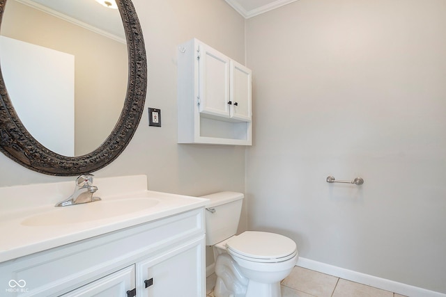 bathroom featuring ornamental molding, vanity, tile patterned flooring, toilet, and baseboards