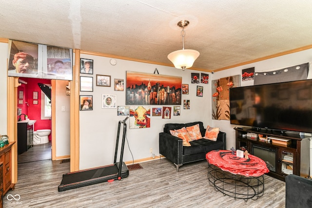 3302 N Gladstone Ave, Indianapolis, IN 46218 - living area featuring wood finished floors, a textured ceiling, crown molding, and baseboards