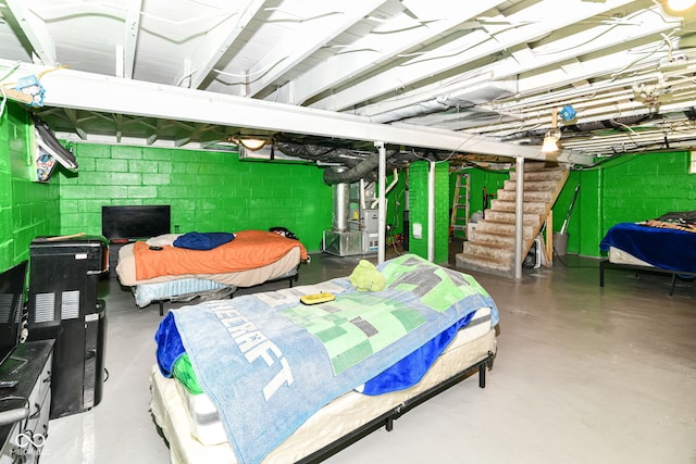 3302 N Gladstone Ave, Indianapolis, IN 46218 - bedroom with concrete floors, concrete block wall, and heating unit