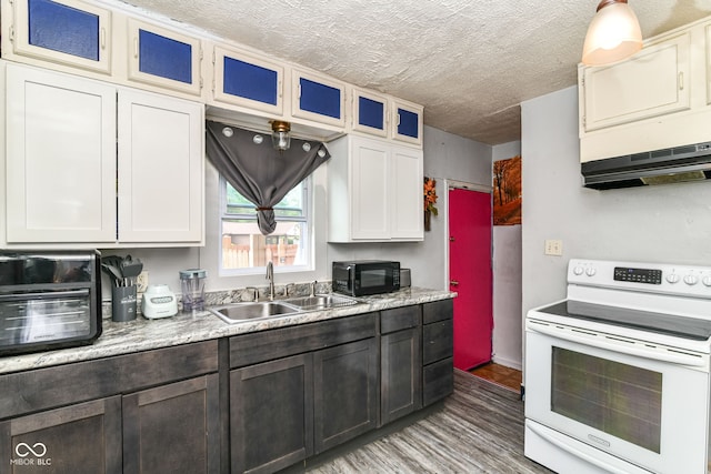 3302 N Gladstone Ave, Indianapolis, IN 46218 - kitchen with white electric range oven, a sink, black microwave, light wood-style flooring, and light countertops
