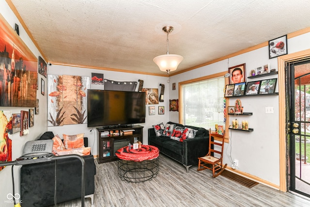 3302 N Gladstone Ave, Indianapolis, IN 46218 - living room with healthy amount of natural light, wood finished floors, a textured ceiling, and ornamental molding