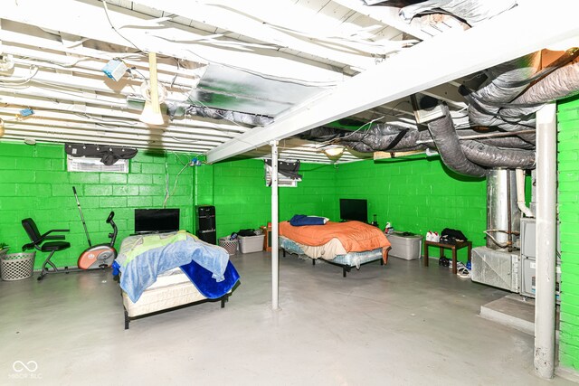 3302 N Gladstone Ave, Indianapolis, IN 46218 - bedroom with concrete flooring and concrete block wall