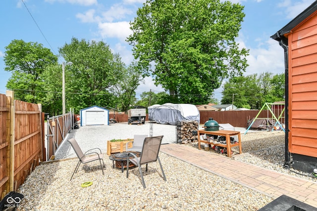 3302 N Gladstone Ave, Indianapolis, IN 46218 - fenced backyard with an outdoor fire pit, a playground, and a patio area