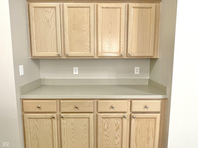 kitchen featuring light brown cabinetry and light countertops