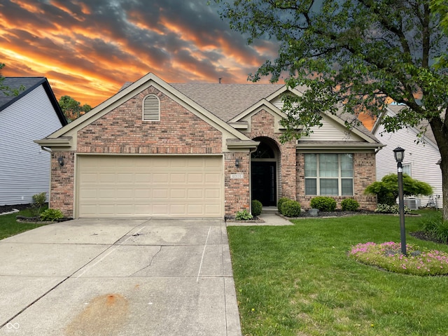 10305 Lakeland Dr, Fishers, IN 46037 - view of front of home with concrete driveway, brick siding, a lawn, and a garage