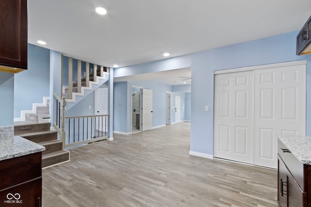 641 E 33rd St, Indianapolis, IN 46205 - unfurnished living room with stairs, light wood-style floors, recessed lighting, and baseboards