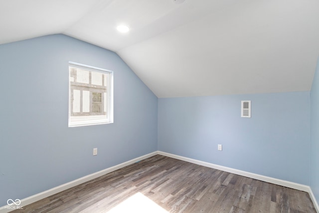 641 E 33rd St, Indianapolis, IN 46205 - additional living space featuring lofted ceiling, wood finished floors, and baseboards