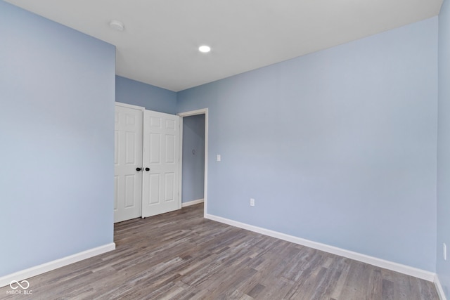 641 E 33rd St, Indianapolis, IN 46205 - unfurnished bedroom featuring wood finished floors, baseboards, a closet, and recessed lighting