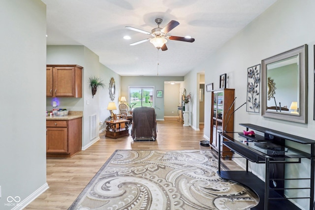 hall featuring light wood-style flooring and baseboards