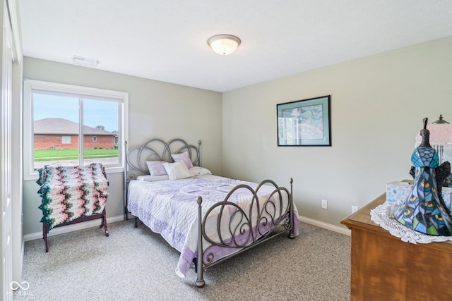 bedroom featuring carpet and baseboards