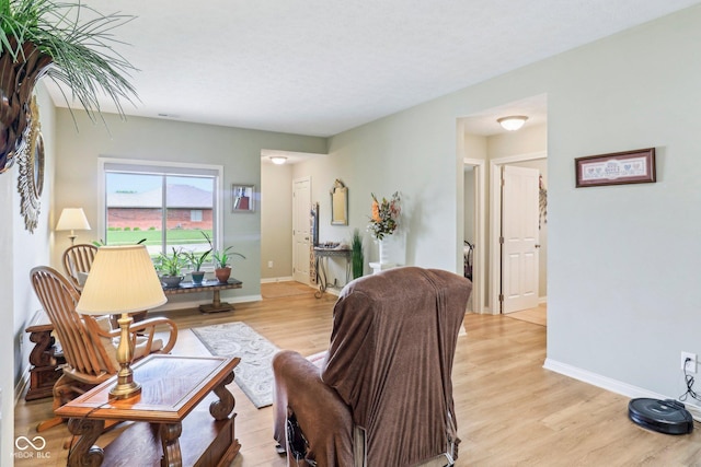 living room featuring light wood-type flooring and baseboards