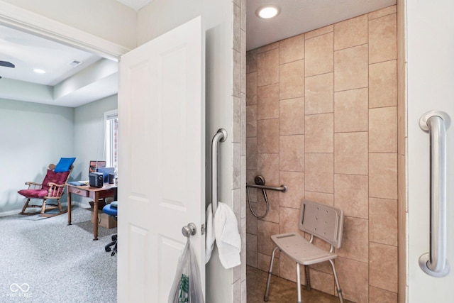 full bathroom with a tile shower and recessed lighting