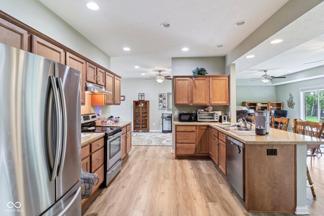 kitchen featuring appliances with stainless steel finishes, under cabinet range hood, a ceiling fan, a peninsula, and recessed lighting