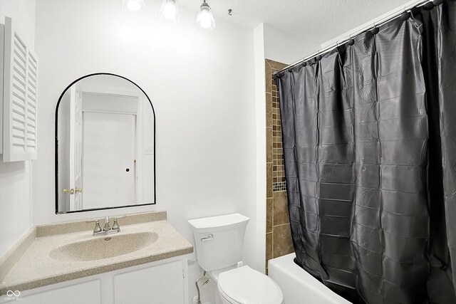 7642 Lancer Ln, Lawrence, IN 46226 - bathroom with vanity, toilet, shower / bathtub combination with curtain, and a textured ceiling