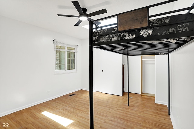 7642 Lancer Ln, Lawrence, IN 46226 - unfurnished bedroom with wood finished floors, baseboards, and ceiling fan