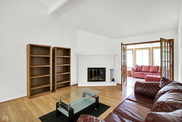 7642 Lancer Ln, Lawrence, IN 46226 - living area with wood finished floors, a brick fireplace, and baseboards