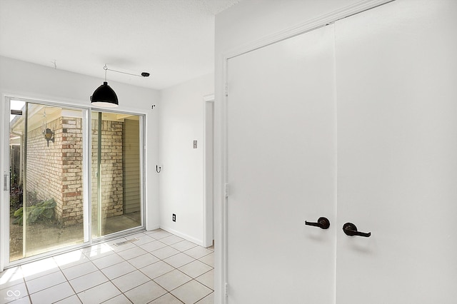 7642 Lancer Ln, Lawrence, IN 46226 - hall with light tile patterned floors and baseboards