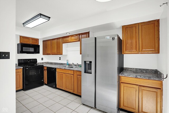 7642 Lancer Ln, Lawrence, IN 46226 - kitchen featuring black appliances, a sink, light tile patterned floors, and brown cabinetry