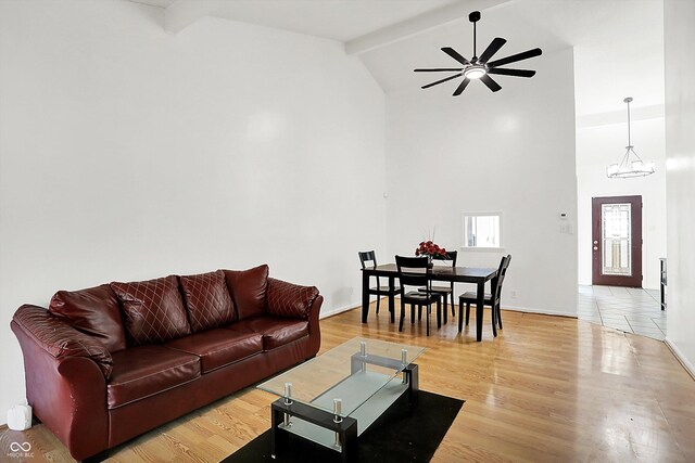 7642 Lancer Ln, Lawrence, IN 46226 - living room with high vaulted ceiling, beamed ceiling, ceiling fan, light wood finished floors, and a chandelier
