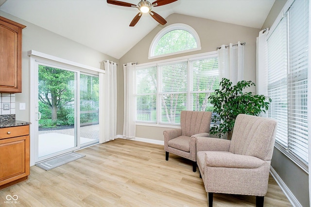 sitting room featuring a ceiling fan, light wood finished floors, lofted ceiling, and baseboards