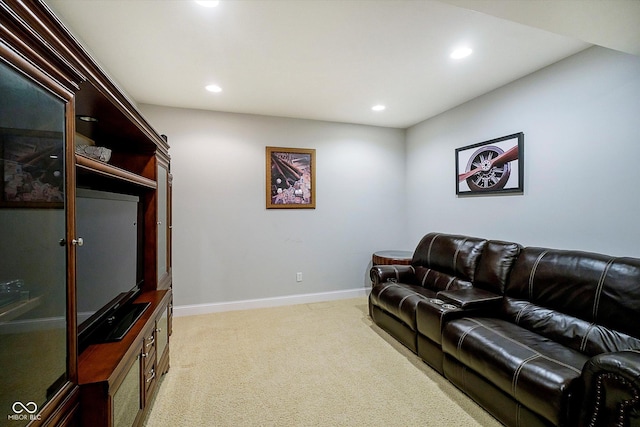 living area featuring light colored carpet, recessed lighting, and baseboards