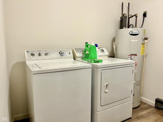 124 Brookside Dr, Hope, IN 47246 - washroom featuring electric water heater, washing machine and dryer, light wood finished floors, and baseboards
