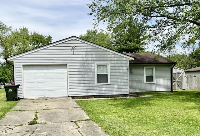 124 Brookside Dr, Hope, IN 47246 - view of side of home with concrete driveway, a yard, a garage, an outdoor structure, and a shed
