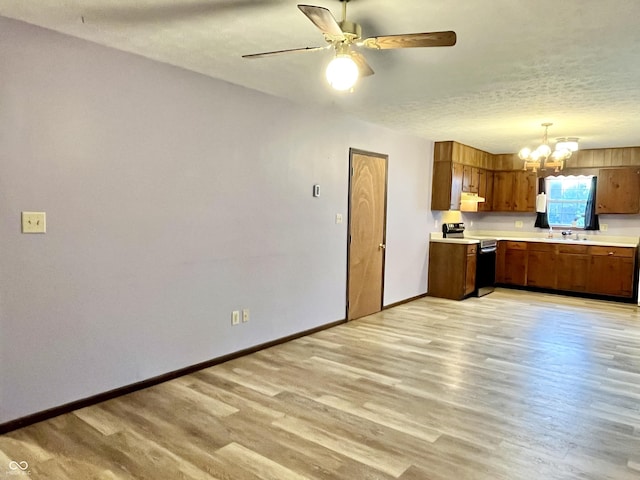 124 Brookside Dr, Hope, IN 47246 - kitchen with electric range, a chandelier, light countertops, light wood-style floors, and brown cabinets