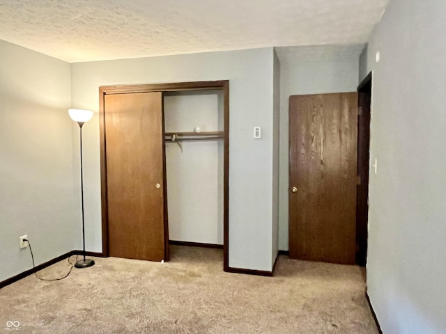 124 Brookside Dr, Hope, IN 47246 - unfurnished bedroom featuring carpet floors, baseboards, a closet, and a textured ceiling