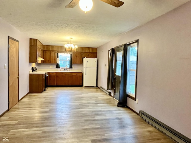 124 Brookside Dr, Hope, IN 47246 - kitchen with freestanding refrigerator, a baseboard heating unit, electric range, a chandelier, and brown cabinetry