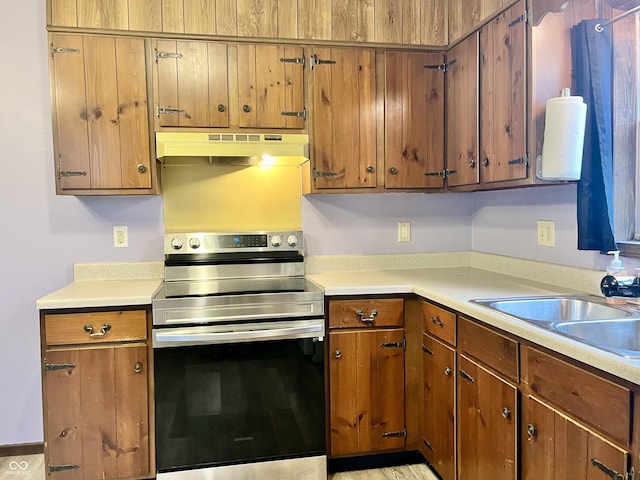 124 Brookside Dr, Hope, IN 47246 - kitchen featuring under cabinet range hood, electric stove, a sink, and light countertops