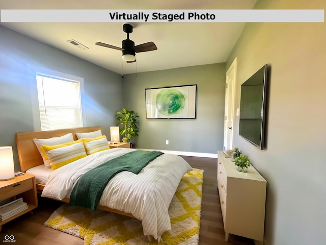 bedroom featuring dark wood-style flooring, baseboards, and ceiling fan