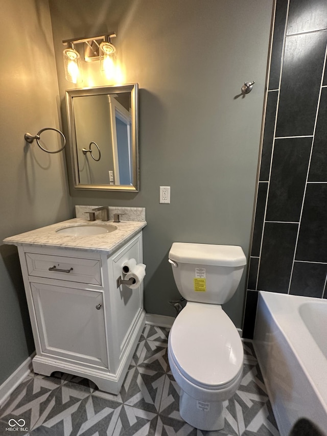 full bath with toilet, vanity, and baseboards