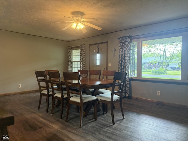 dining room with wood finished floors, ceiling fan, healthy amount of natural light, baseboards, and a textured ceiling